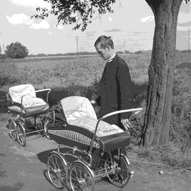 Mężczyzna z dwoma wózkami dziecięcymi